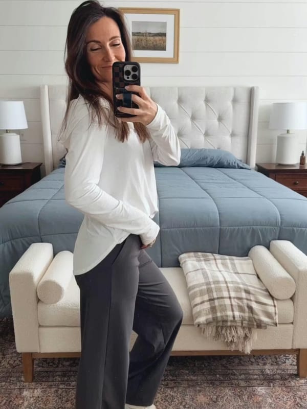 Customer in long-sleeve white tee and gray wide-leg pants